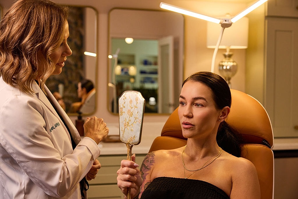 Woman with eyes closed in soft lighting.
