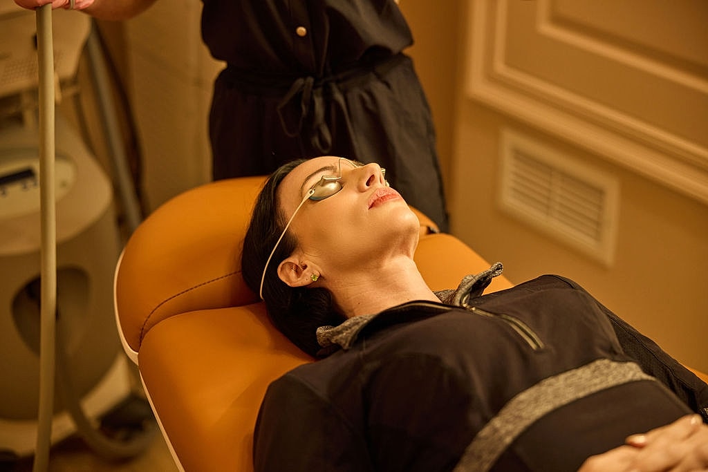 Model with long hair against white background.