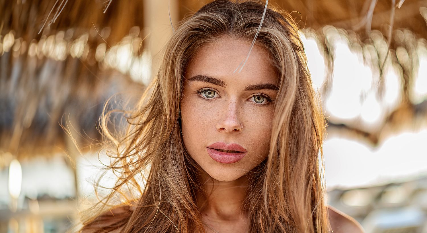 Close-up portrait of a woman with flowing hair.