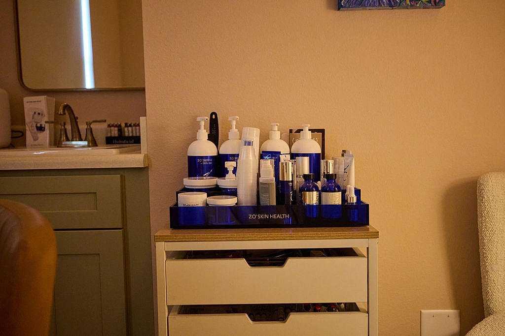 Smiling woman sitting in a cozy setting.